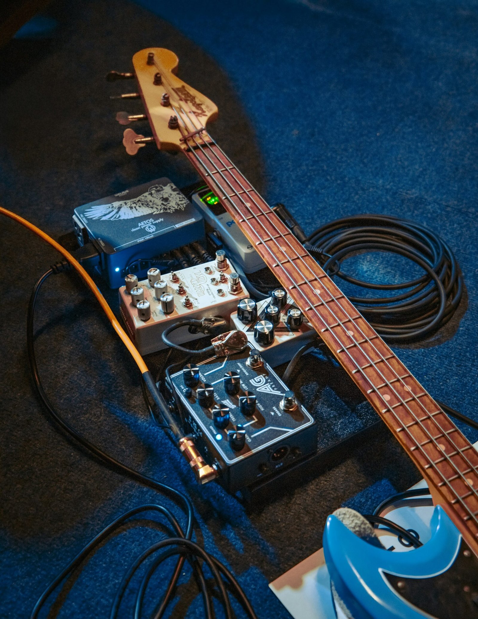 A bass guitar sitting on top of a blue carpet